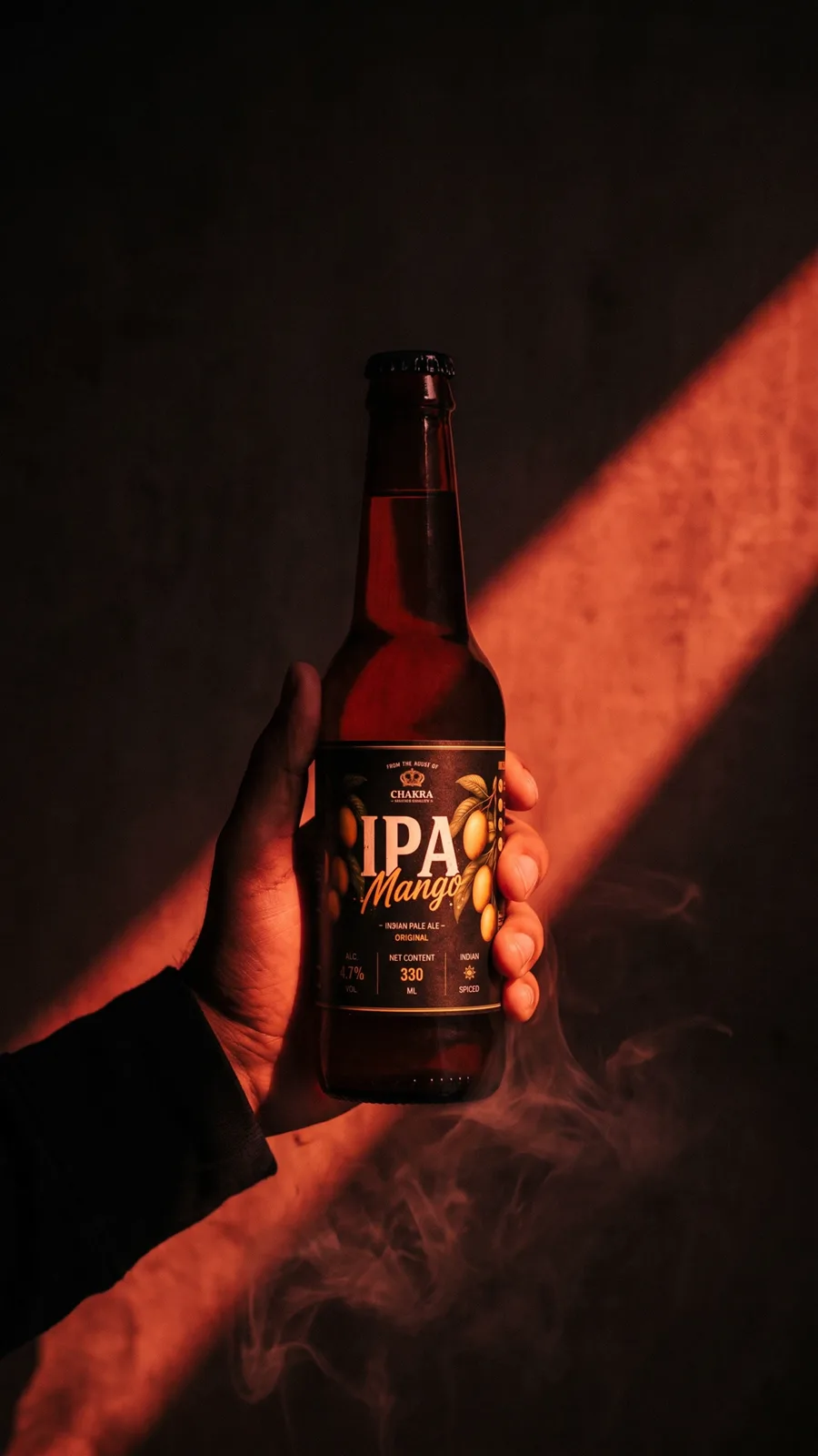 A hand holding a bottle of Chakra IPA Mango in a beam of warm light